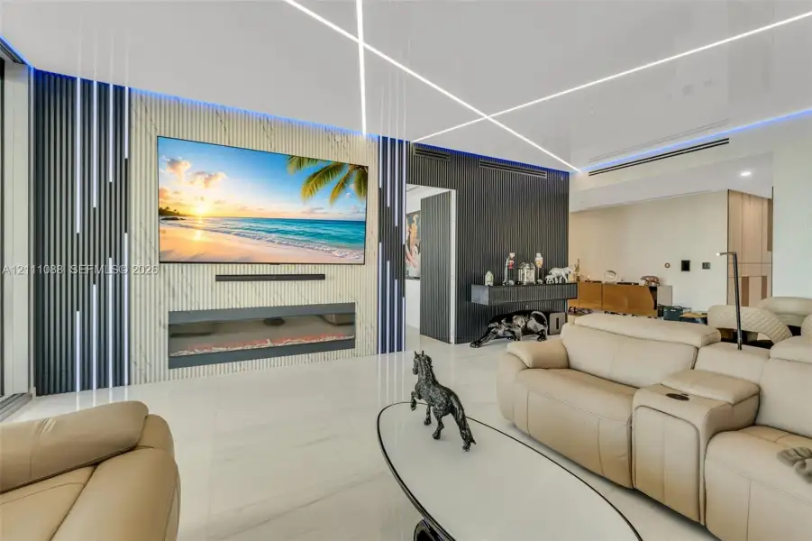 Feature wall with stone-finish cladding and integrated linear lighting, flush-mounted electric fireplace, vertical slat accent detailing, and large-format porcelain tile flooring Feature wall with stone-finish cladding and integrated linear lighting, flush-mounted electric fireplace, vertical slat accent detailing, and large-format porcelain tile flooring