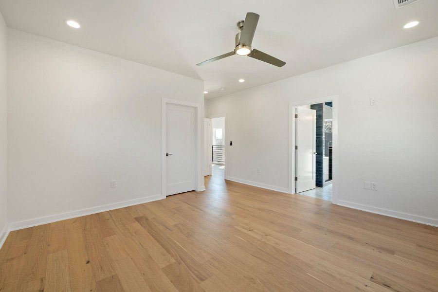 Empty room with baseboards, ceiling fan, light wood finished floors, and recessed lighting
