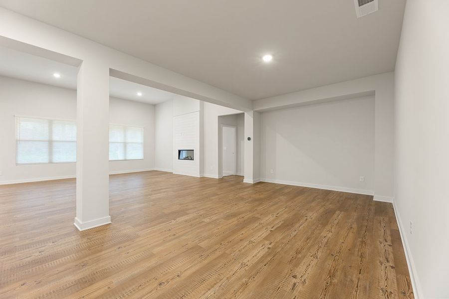 A room with a wood floor and white walls.