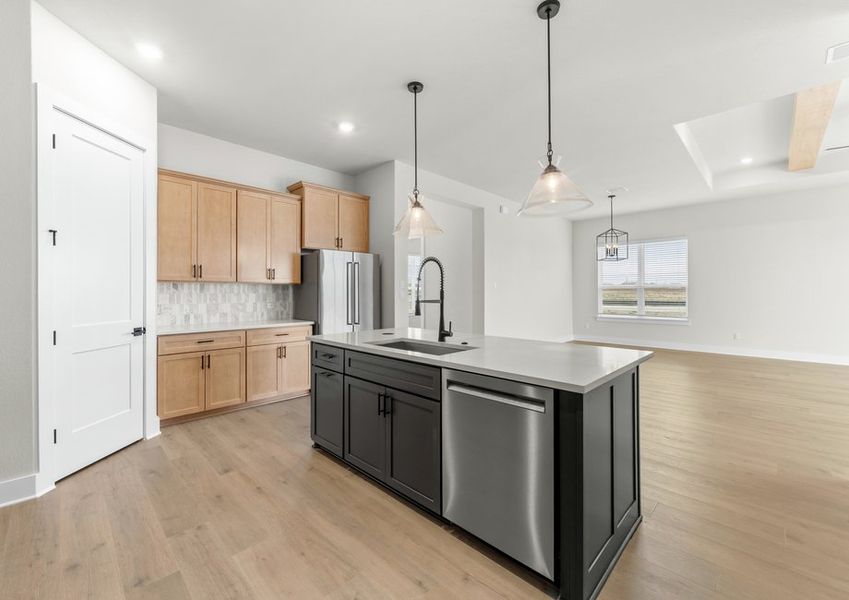 The kitchen looks out into the dining area and living room.