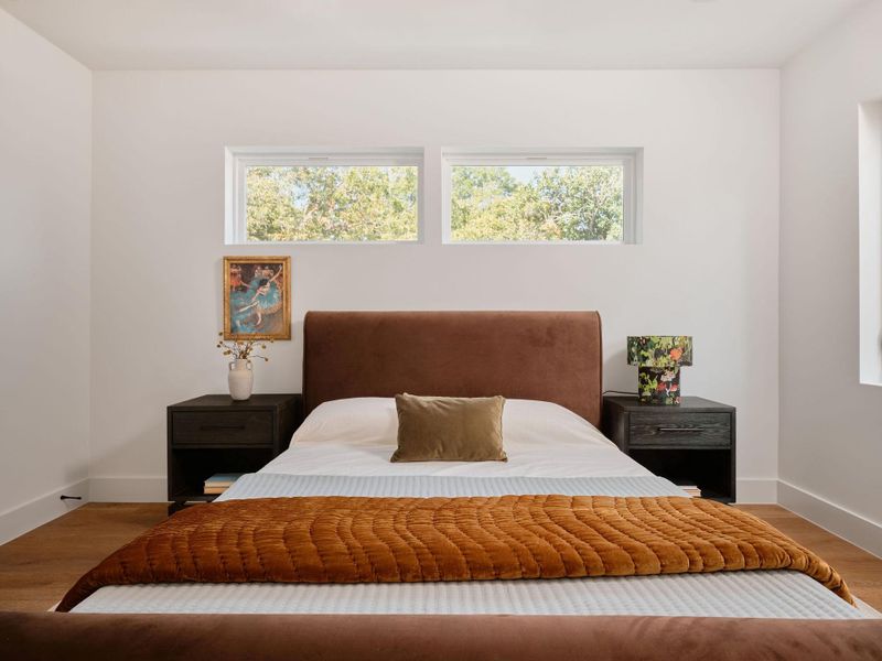 Bedroom with wood finished floors and baseboards Bedroom with wood finished floors and baseboards