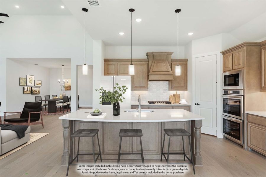 Kitchen with large center island, wood cabinets, pendant lights, and stainless steel appliances open to dining area Kitchen with large center island, wood cabinets, pendant lights, and stainless steel appliances open to dining area