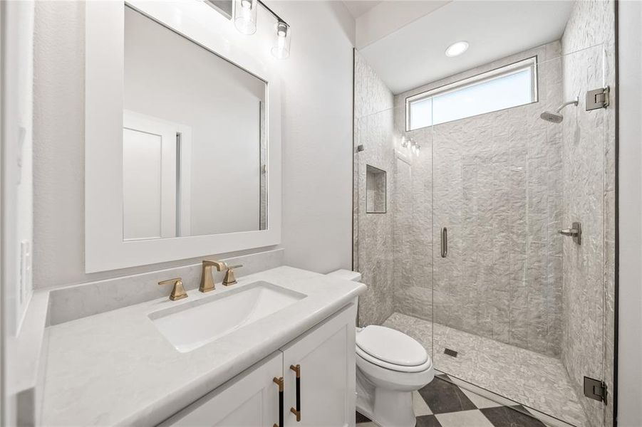 Bathroom with vanity, a shower stall, light flooring, and recessed lighting
