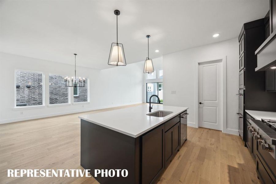 With the kitchen open to the dining and family rooms, the chef will never be left out of the party in this fantastic home!  REPRESENTATIVE PHOTO