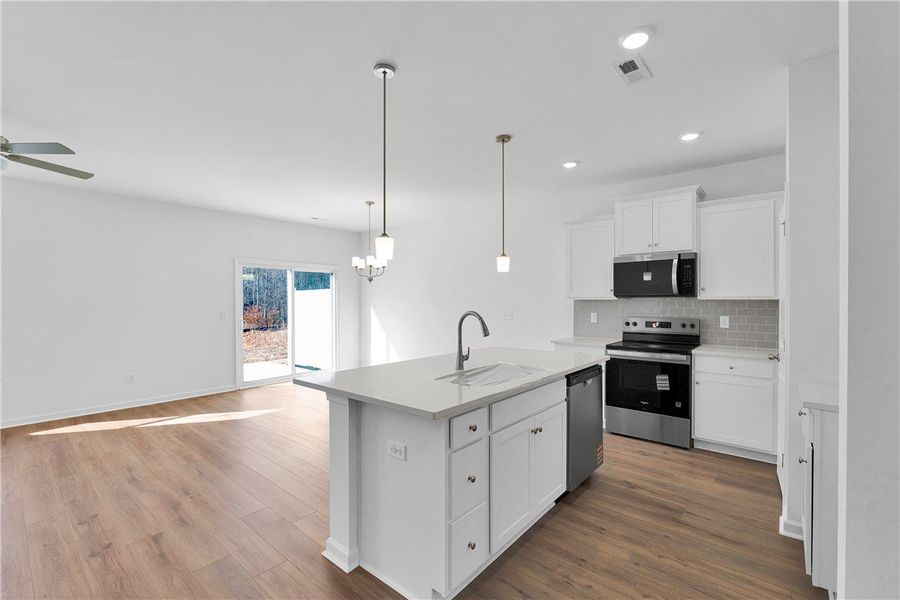 This kitchen and living area showcases a bright op This kitchen and living area showcases a bright op