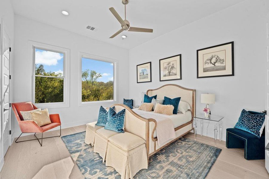 Bedroom with light wood-style floors, a ceiling fan, and recessed lighting