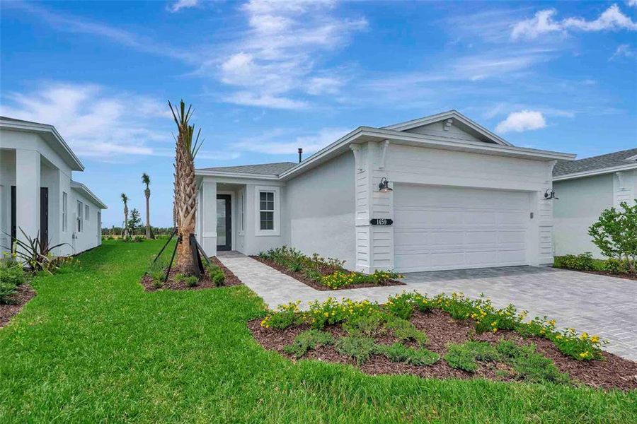 Front exterior of a new home in Cresswind at Lake Harris, Tavares, FL, highlighting curb appeal (Image 2).