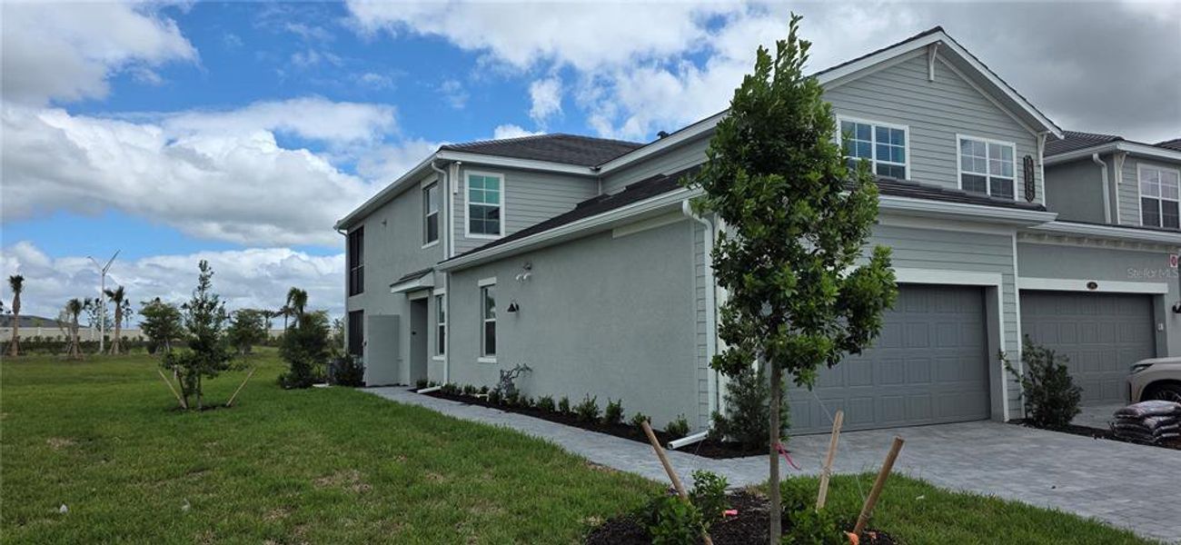 Front exterior of a new home in Calusa Country Club, Lakewood Ranch, FL, highlighting curb appeal (Image 2).