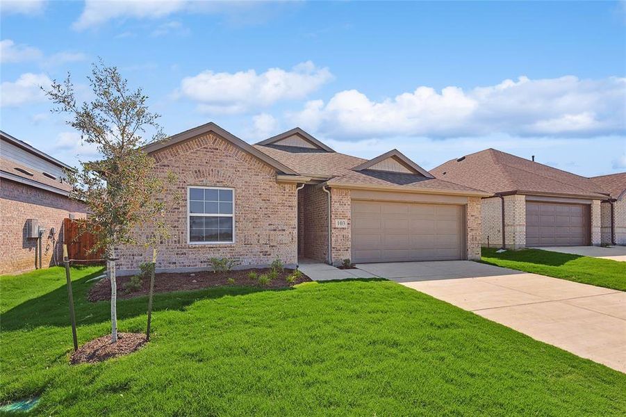 View of front of home featuring a garage and a front yard