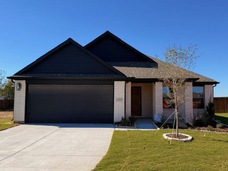 Front exterior of a new home in , Venus, TX, highlighting curb appeal (Image 1).
