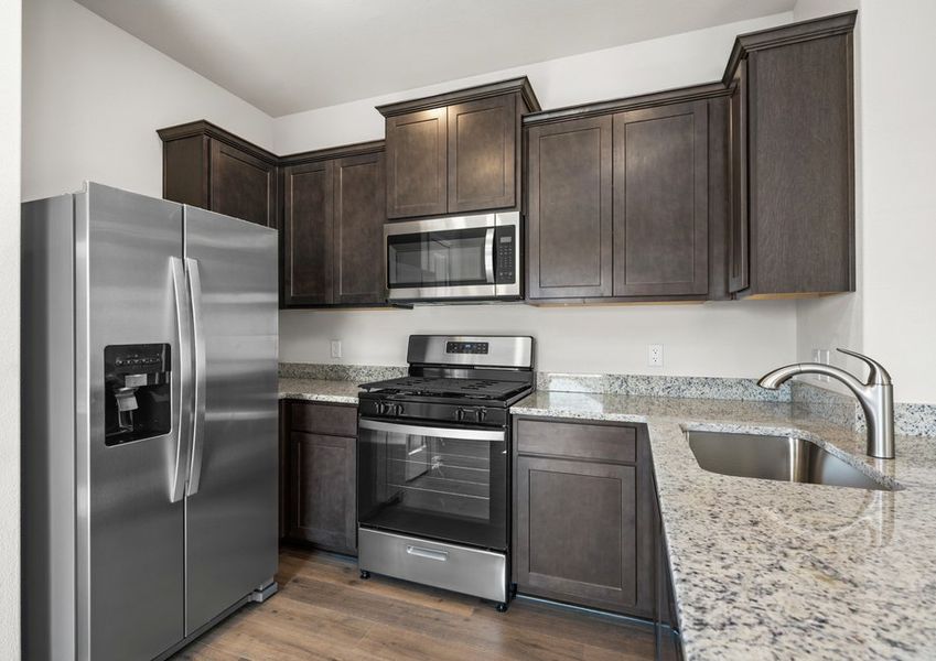 The kitchen has beautiful brown cabinets.
