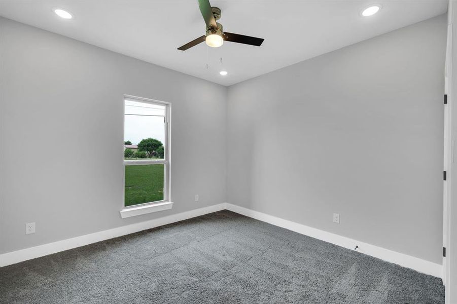 Empty room featuring ceiling fan and carpet