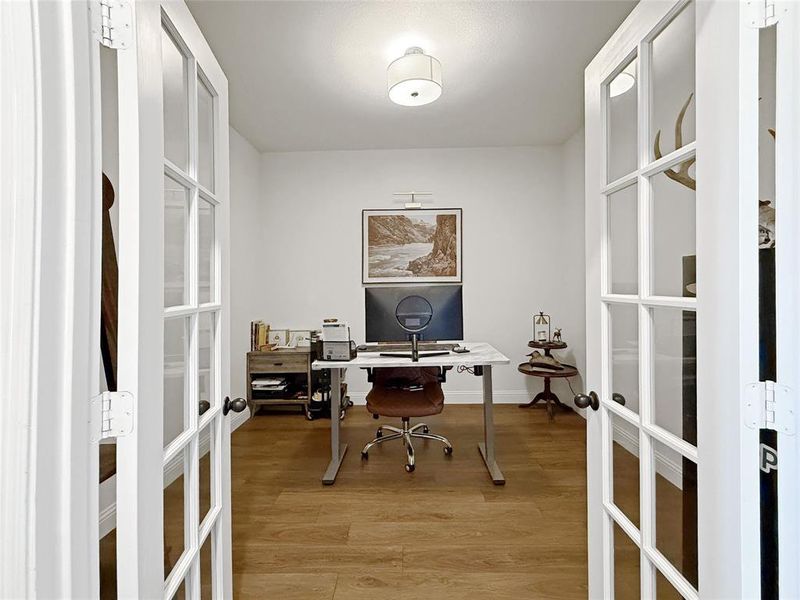 Home office with french doors and light wood finished floors Home office with french doors and light wood finished floors