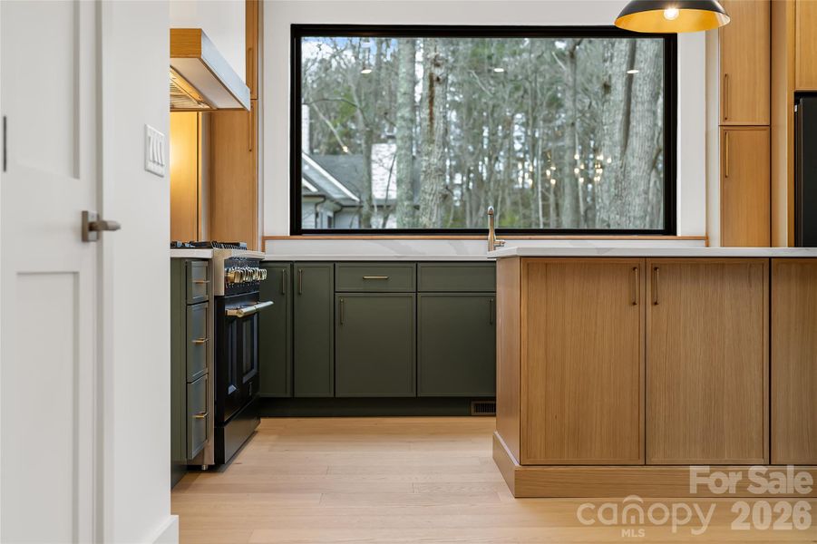 Expansive picture window flooding the kitchen with natural light