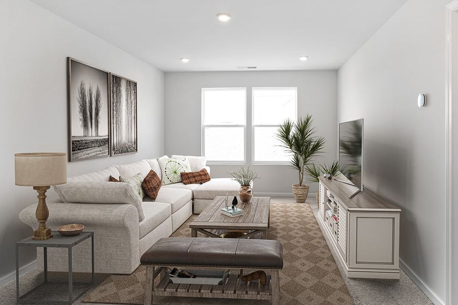 A living room with a couch and coffee table. A living room with a couch and coffee table.