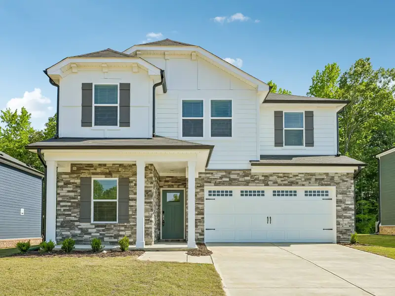 Front exterior of a new home in Cadence Meadows, Zebulon, NC, highlighting curb appeal (Image 1). Front exterior of a new home in Cadence Meadows, Zebulon, NC, highlighting curb appeal (Image 1).
