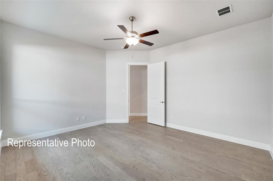 Spare room featuring hardwood / wood-style flooring and ceiling fan