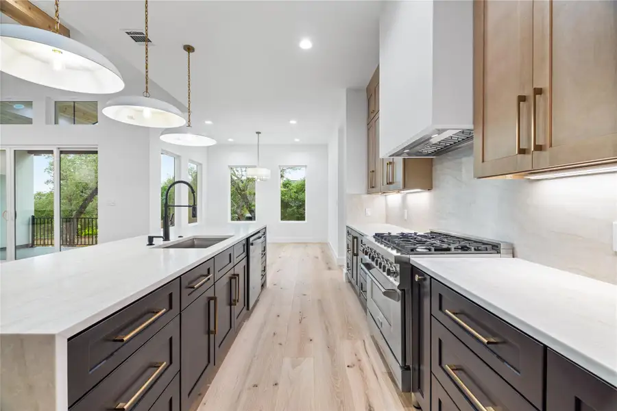View of dining area and nicely tree shaded backyard from Kitchen. countertops, stainless steel appliances, and recessed lighting View of dining area and nicely tree shaded backyard from Kitchen. countertops, stainless steel appliances, and recessed lighting