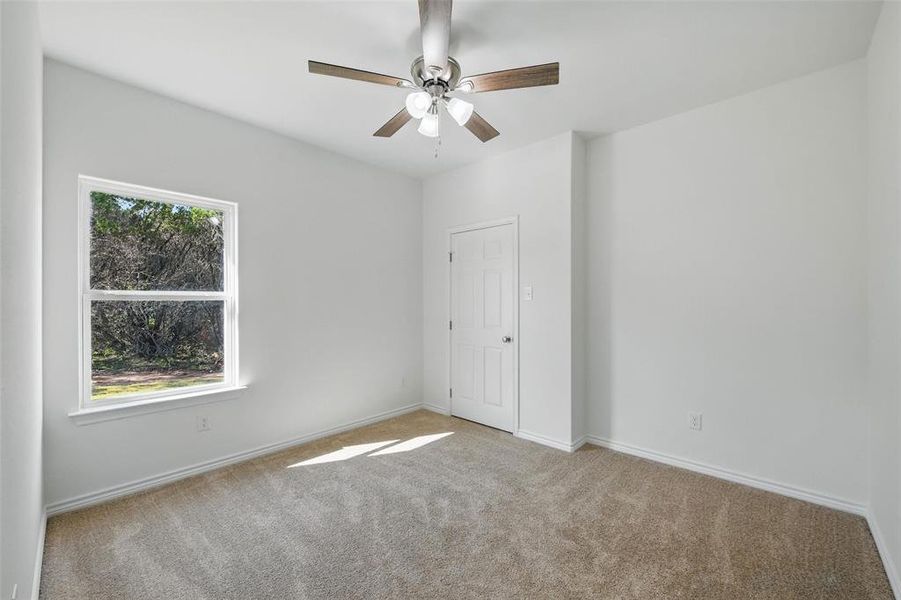 Unfurnished bedroom featuring carpet flooring, baseboards, and a ceiling fan Unfurnished bedroom featuring carpet flooring, baseboards, and a ceiling fan