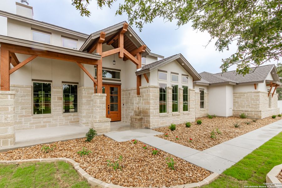 Front exterior of a new home in , La Vernia, TX, highlighting curb appeal (Image 27).