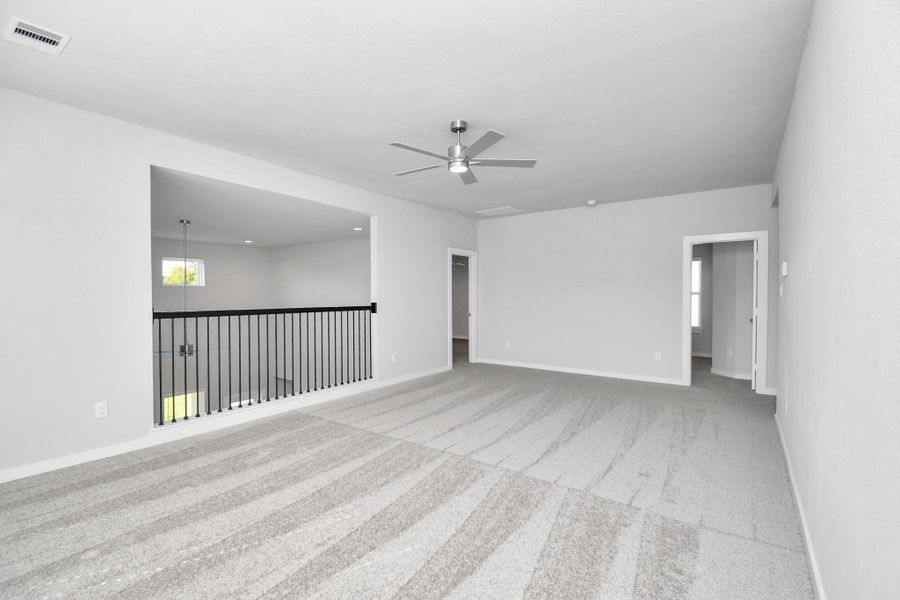 Ascend to relaxation in this fantastic game room! Ideal for both casual gatherings and adult gaming, it boasts plush carpet, lofty ceilings, custom paint, and ample windows for abundant natural light. Sample photo of completed home with similar floor plan. Actual colors and selections may vary. Ascend to relaxation in this fantastic game room! Ideal for both casual gatherings and adult gaming, it boasts plush carpet, lofty ceilings, custom paint, and ample windows for abundant natural light. Sample photo of completed home with similar floor plan. Actual colors and selections may vary.