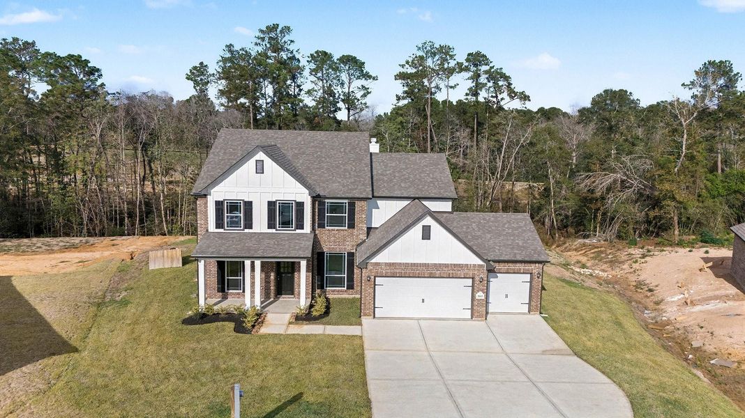 Front exterior of a new home in Oakwood Ranch, Willis, TX, highlighting curb appeal (Image 18).