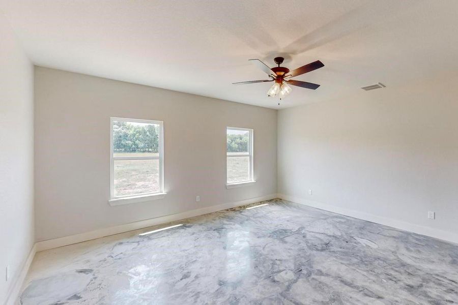 Empty room featuring ceiling fan