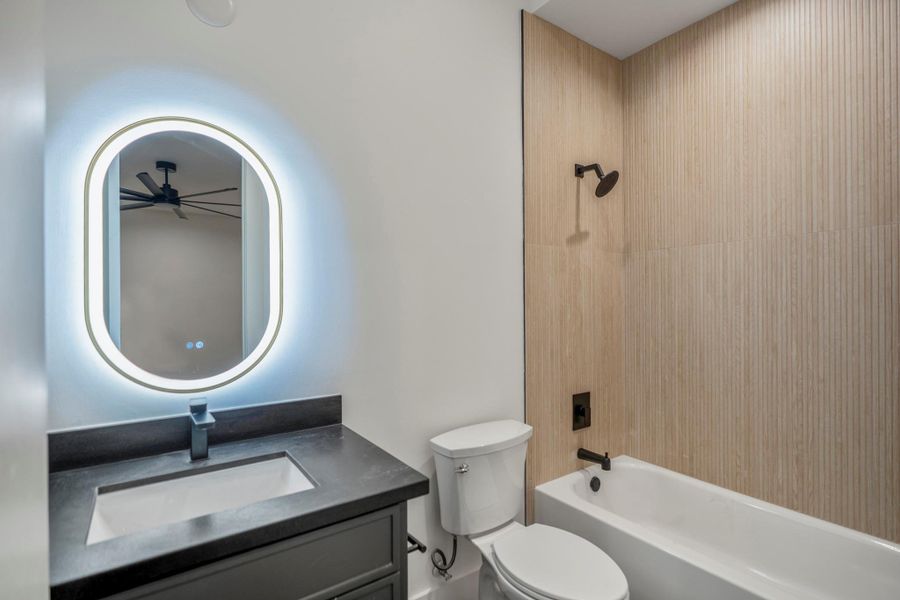 Upstairs full bathroom follows the same aesthetic as the media room and wet bar for a more cozy feeling. Upstairs full bathroom follows the same aesthetic as the media room and wet bar for a more cozy feeling.