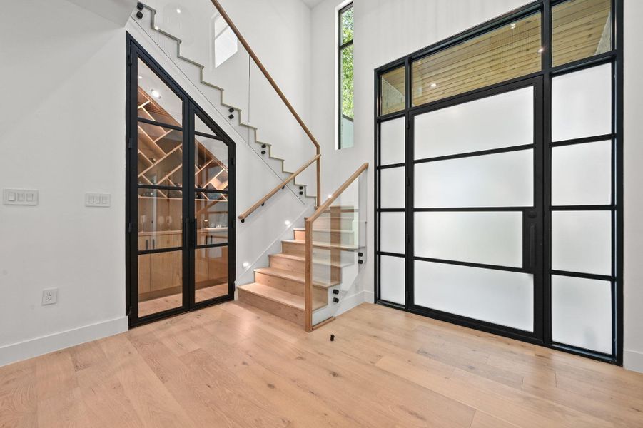 Entrance foyer featuring stairs and light wood finished floors