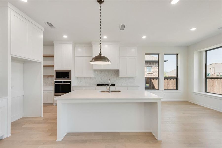Kitchen featuring decorative backsplash, hanging light fixtures, open shelves, wall oven, and recessed lighting Kitchen featuring decorative backsplash, hanging light fixtures, open shelves, wall oven, and recessed lighting