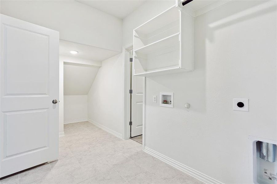 Laundry room with washer hookup, light tile patterned flooring, electric dryer hookup, and hookup for a gas dryer