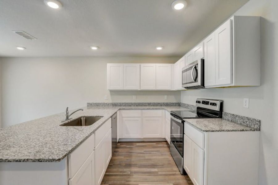 A kitchen with white cabinets. A kitchen with white cabinets.