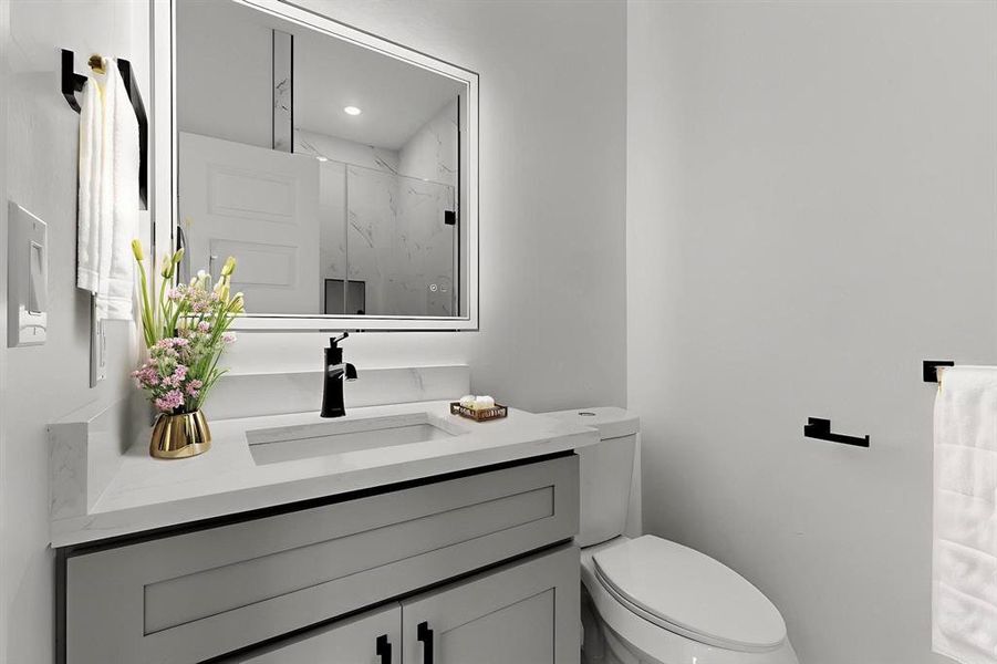 Full bath with vanity and a marble finish shower Full bath with vanity and a marble finish shower