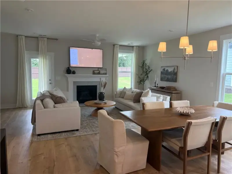 Gleaming hardwood floors and a warm fireplace defi
