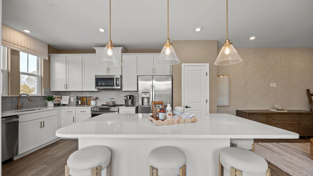 The Rochester Plan by DRB homes kitchen with island in Charlotte, NC.