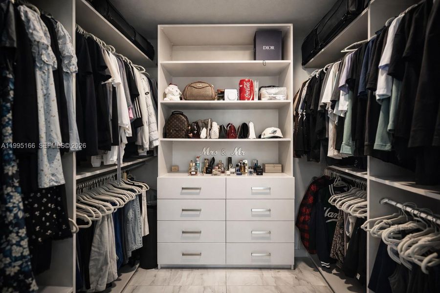 Custom walk-in closet with ample storage space Custom walk-in closet with ample storage space