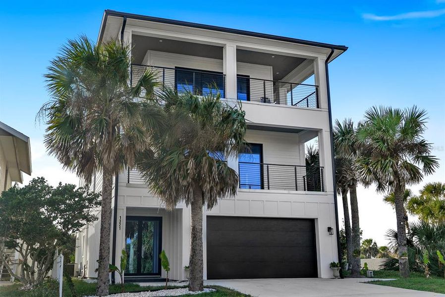 Front exterior of a new home in , Flagler Beach, FL, highlighting curb appeal (Image 1).
