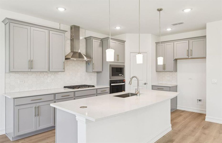 Large island overlooking gathering room and dining areas