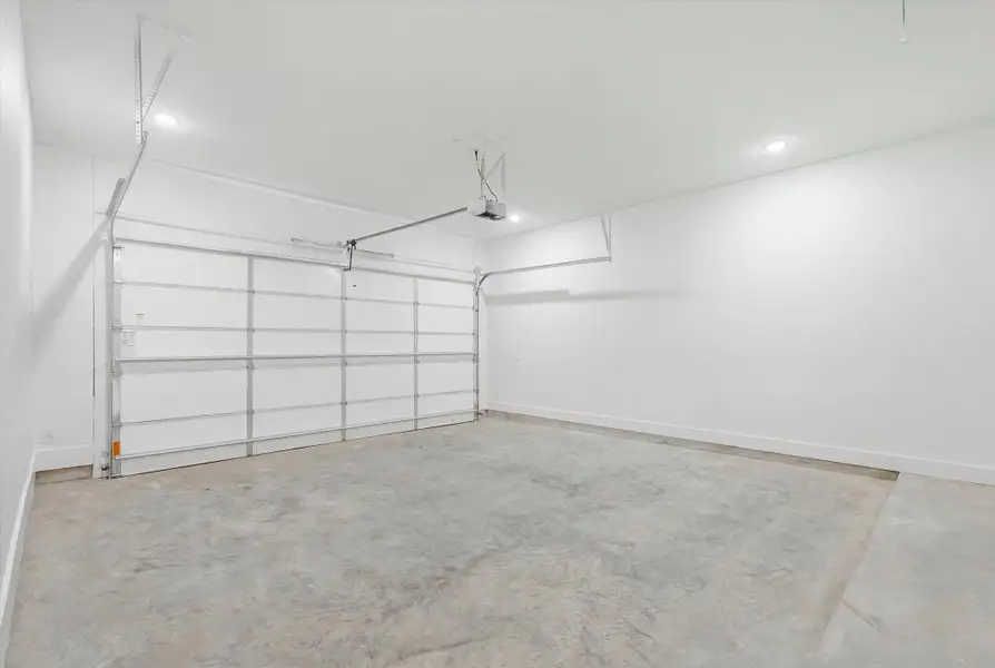 Fully finished two-car garage with bright white walls, plenty of lighting and an automatic garage door opener. Fully finished two-car garage with bright white walls, plenty of lighting and an automatic garage door opener.