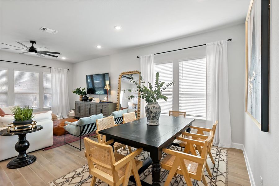 Dining area featuring light wood finished floors, ceiling fan, recessed lighting, and healthy amount of natural light