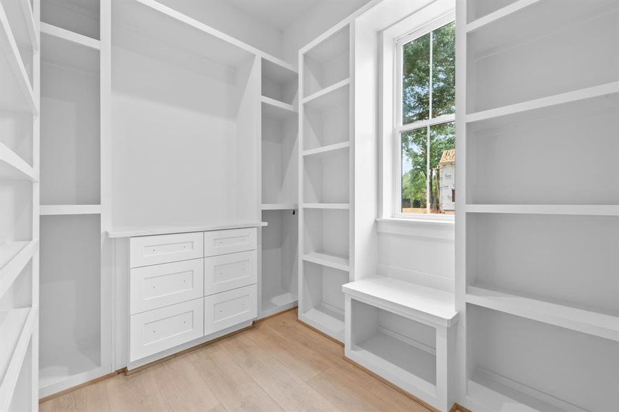 Natural light in closet with window seat.