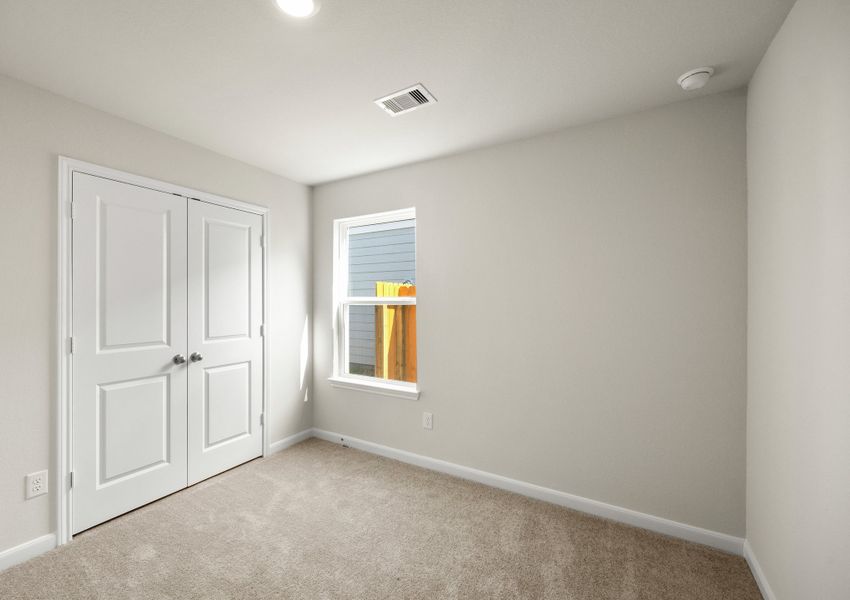 Secondary bedroom with a double door closet
