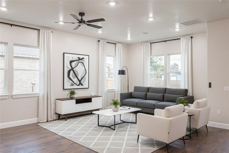Living area with wood finished floors, a ceiling fan, and recessed lighting Living area with wood finished floors, a ceiling fan, and recessed lighting