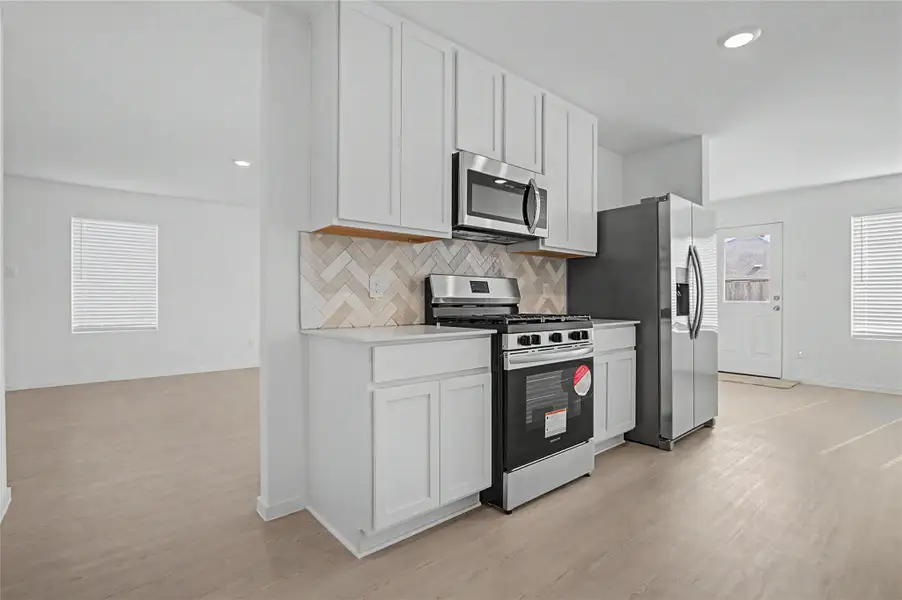 Furnished interior view inside a new home in Sunterra, Katy (Image 11).