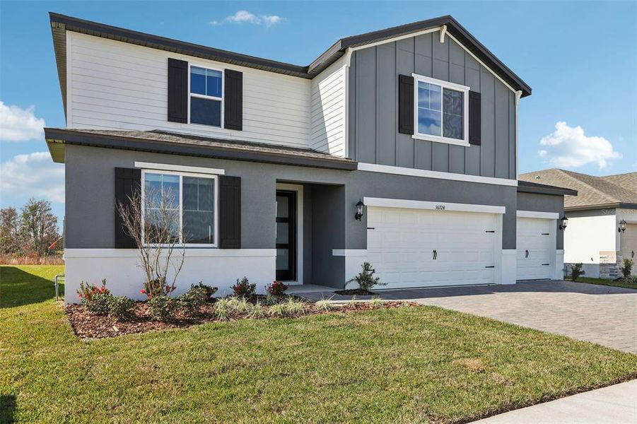 Front exterior of a new home in Two Rivers - Signature Series, Zephyrhills, FL, highlighting curb appeal (Image 24). Front exterior of a new home in Two Rivers - Signature Series, Zephyrhills, FL, highlighting curb appeal (Image 24).