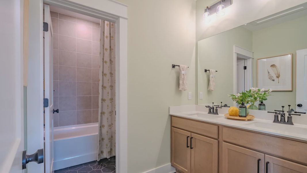 Spacious secondary bathroom with dual vanity and separate shower area Spacious secondary bathroom with dual vanity and separate shower area