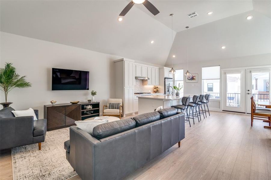 This is a great view of the open concept floor plan with is perfect for entertaining.  The entire living area is covered in more light colored luxury vinyl plank flooring.