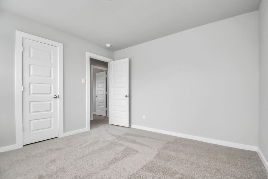 Generously sized secondary bedrooms featuring spacious closets, soft and inviting carpeting underfoot, large windows allowing plenty of natural light, and the added touch of privacy blinds for your personal retreat. Sample photo of completed home with similar floor plan. Actual colors and selections may vary.