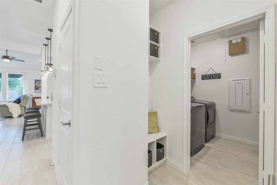 The conveniently located mud room is right off the garage and features cubbies, hooks, and additional shelving. The laundry room is close by for easy clean up.