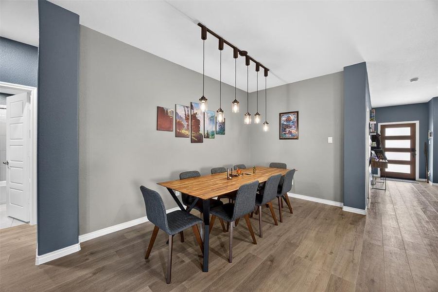 Dining room featuring rail lighting and light wood finished floors